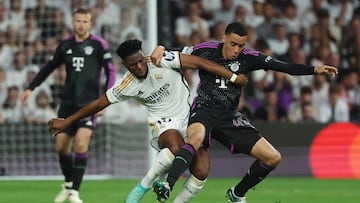 Real Madrid's French defender #18 Aurelien Tchouameni (L) and Bayern Munich's German midfielder #42 Jamal Musiala vie for the ball during the UEFA Champions League semi final second leg football match between Real Madrid CF and FC Bayern Munich at the Santiago Bernabeu stadium in Madrid on May 8, 2024. (Photo by Pierre-Philippe MARCOU / AFP)