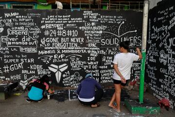 Los fans escriben mensajes en memoria de Kobe Bryant en la cancha de baloncesto de una vivienda en Taguig City, Metro Manila, Filipinas.
