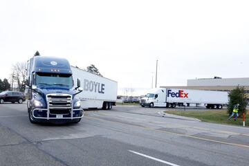 Trucks carrying the first shipment of the Covid-19 vaccine that is being escorted by the US Marshals Service, leave Pfizer's Global Supply facility in Kalamazoo, Michigan on 13 December 2020.