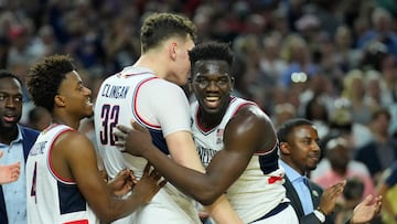 Apr 3, 2023; Houston, TX, USA; Connecticut Huskies forward Adama Sanogo (21) and Connecticut Huskies center Donovan Clingan (32) celebrate in the second half against the San Diego State Aztecs in the national championship game of the 2023 NCAA Tournament at NRG Stadium. Mandatory Credit: Robert Deutsch-USA TODAY Sports