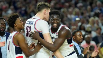 Apr 3, 2023; Houston, TX, USA; Connecticut Huskies forward Adama Sanogo (21) and Connecticut Huskies center Donovan Clingan (32) celebrate in the second half against the San Diego State Aztecs in the national championship game of the 2023 NCAA Tournament at NRG Stadium. Mandatory Credit: Robert Deutsch-USA TODAY Sports