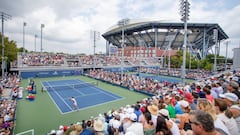 A general view of the packed viewing areas on the outside courts as Sebastian Korda of the United States plays against Facundo Bagnis of Argentina on Court Four with the backdrop of Arthur Ashe Stadium on day one of the US Open Tennis Championship 2022.