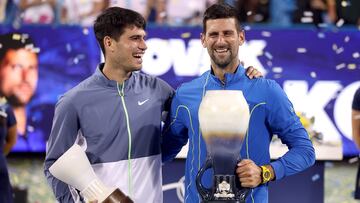 Alcaraz y Djokovic sonríen con los trofeos de subcampeón y campeón, respectivamente.