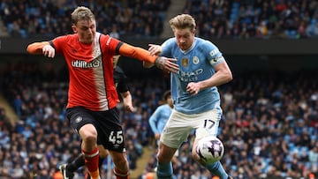 Luton Town's English midfielder #45 Alfie Doughty (L) vies with Manchester City's Belgian midfielder #17 Kevin De Bruyne (R) during the English Premier League football match between Manchester City and Luton Town at the Etihad Stadium in Manchester, north west England, on April 13, 2024. (Photo by Darren Staples / AFP) / RESTRICTED TO EDITORIAL USE. No use with unauthorized audio, video, data, fixture lists, club/league logos or 'live' services. Online in-match use limited to 120 images. An additional 40 images may be used in extra time. No video emulation. Social media in-match use limited to 120 images. An additional 40 images may be used in extra time. No use in betting publications, games or single club/league/player publications. /
