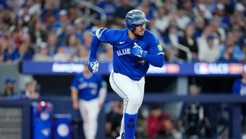 TORONTO, ONTARIO - OCTOBER 12: Anthony Santander #25 of the Toronto Blue Jays hits a single against the Seattle Mariners during the second inning in game one of the American League Championship Series at Rogers Centre on October 12, 2025 in Toronto, Ontario. Mark Blinch/Getty Images/AFP (Photo by MARK BLINCH / GETTY IMAGES NORTH AMERICA / Getty Images via AFP)
