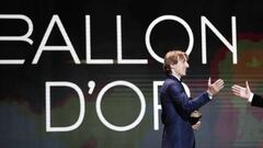 Real Madrid's Luke Modric hands the Ballon d'Or trophy with 2019 winner Lionel Messi.