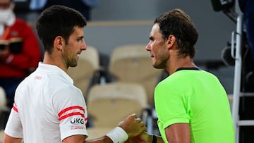 Serbia&#039;s Novak Djokovic (L) and Spain&#039;s Rafael Nadal shake hands at the end of their men&#039;s singles semi-final tennis match on Day 13 of The Roland Garros 2021 French Open tennis tournament in Paris on June 11, 2021. (Photo by MARTIN BUREAU / AFP)