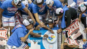 Mar 12, 2022; Kansas City, MO, USA; Kansas Jayhawks place their logo on the March Madness tournament ticket after the game against the Texas Tech Red Raiders at T-Mobile Center. Mandatory Credit: William Purnell-USA TODAY Sports