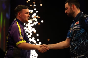 Luke Humphries and England's Luke Littler shake hands after their quarter-final darts match.