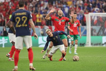 Sofyan Amrabat fights for the ball with Antoine Griezmann.