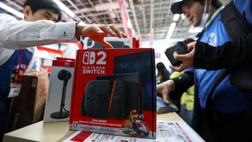 A man buys a Nintendo Switch 2 gaming device as Nintendo starts selling the new consoles globally, at an electronics store in Tokyo, Japan June 5, 2025. REUTERS/Issei Kato