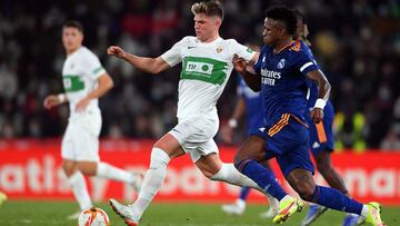 ELCHE, SPAIN - JANUARY 20: Vinicius Junior of Real Madrid tackles Raul Guti of Elche during the Copa Del Rey match between Elche and Real Madrid at Estadio Martinez Valero on January 20, 2022 in Elche, Spain. (Photo by Aitor Alcalde/Getty Images)