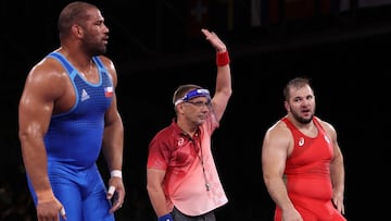 CHIBA, JAPAN - AUGUST 02: A wrestling official wearing a face shield declares the winner in the match between Yasmani Acosta Fernandez of Team Chile competes against Sergei Semenov of Team Russian Olympic Committee during the Men&#039;s Greco-Roman 130kg Bronze Medal Match on day ten of the Tokyo 2020 Olympic Games at Makuhari Messe Hall on August 02, 2021 in Chiba, Japan. (Photo by Tom Pennington/Getty Images)