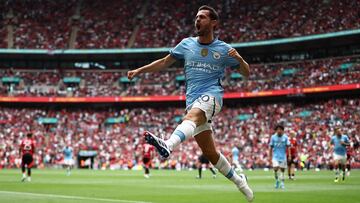 Manchester City's Portuguese midfielder #20 Bernardo Silva celebrates after scoring the equalising goal during the English FA Community Shield football match between Manchester City and Manchester United at Wembley Stadium, in London on August 10, 2024. (Photo by HENRY NICHOLLS / AFP) / NOT FOR MARKETING OR ADVERTISING USE / RESTRICTED TO EDITORIAL USE