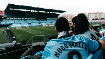 Dos aficionados del Celta observan abrazados el terreno de juego de Bala&iacute;dos. 