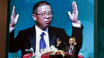 This photo taken on May 6, 2013 shows Zhong Shanshan, chairman of Nongfu Spring mineral water and a separate pharma company, gesturing during a speech at a press conference in Beijing. - Until recently, few people had even heard of the Chinese billionaire with a gruff reputation who built a fortune on China's seemingly unquenchable demand for his ubiquitous red-capped bottled water. (Photo by STR / CNS / AFP) / China OUT / TO GO WITH China-business-wealth-Asia,PROFILE by Helen Roxburgh and Danni Zhu