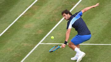 Feliciano Lopez of Spain returns a ball to France's Gilles Simon during their match at the ATP Tour tennis tournament in Stuttgart, southern Germany, on June 14, 2018. / AFP PHOTO / dpa / Marijan Murat / Germany OUT