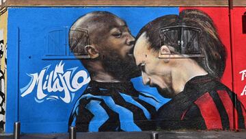 A picture taken in Milan on February 15, 2021 shows a street art mural by an unknown artist on a wall near the San Siro stadium, depicting AC Milan&#039;s Swedish forward Zlatan Ibrahimovic headbutting Inter Milan&#039;s Belgian forward Romelu Lukaku, a g