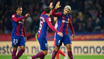 (From L) Barcelona's French defender #23 Jules Kounde, Barcelona's Danish defender #15 Andreas Christensen and Barcelona's Uruguayan defender #04 Ronald Araujo celebrate their win at the end of the Spanish league football match between FC Barcelona and Club Atletico de Madrid at the Estadi Olimpic Lluis Companys in Barcelona on December 3, 2023. (Photo by Pau BARRENA / AFP)