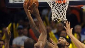 Serge Ibaka trata de evitar ka canasta de DeMarcus Cousins.