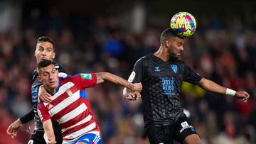 GRANADA, SPAIN - FEBRUARY 27: Myrto Uzuni of Granada CF and Jonas Ramalho of Malaga CF battle for the ball during the LaLiga Smartbank match between Granada CF and Malaga CF at Estadio Nuevo Los Carmenes on February 27, 2023 in Granada, Spain. (Photo by Fermin Rodriguez/Quality Sport Images/Getty Images)