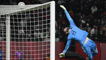 TOPSHOT - Algeria's goalkeeper #23 Luca Zidane dives to stop the ball during the Africa Cup of Nations (CAN) Group E football match between Algeria and Burkino Faso at Moulay Hassan Stadium in Rabat on December 28, 2025. (Photo by Paul ELLIS / AFP)