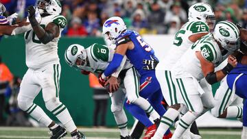 Oct 14, 2024; East Rutherford, New Jersey, USA; New York Jets quarterback Aaron Rodgers (8) is sacked by Buffalo Bills defensive end AJ Epenesa (57) during the first half at MetLife Stadium. Mandatory Credit: Ed Mulholland-Imagn Images