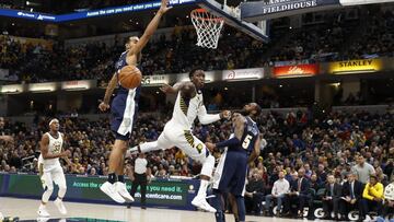 Dec 10, 2017; Indianapolis, IN, USA; Indiana Pacers guard Victor Oladipo (4) makes a pass against Denver Nuggets forward Trey Lyles (7) and guard Will Burton (5) during the 4th quarter at Bankers Life Fieldhouse. Mandatory Credit: Brian Spurlock-USA TODAY Sports