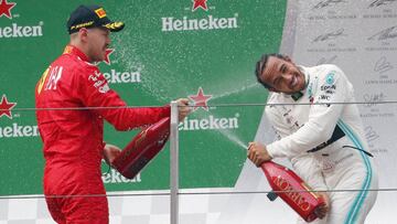 Shanghai (China), 14/04/2019.- First placed British Formula One driver Lewis Hamilton of Mercedes AMG GP (R) and third placed German Formula One driver Sebastian Vettel of Scuderia Ferrari celebrate with champagne during the award ceremony after the Chinese Formula One Grand Prix at the Shanghai International circuit in Shanghai, China, 14 April 2019. (Fórmula Uno) EFE/EPA/WU HONG