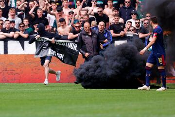 El partido llevaba seis minutos de juego cuando varios hinchas locales saltaron al campo con begalas y botes de humo. Su intención era reventar el partido. Y lo consiguieron.