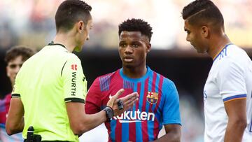 Jose Maria Sanchez Martinez, referee of the match, talks to Ansu Fati of FC Barcelona during the spanish league, La Liga Santander, football match played between FC Barcelona and Real Madrid at Camp Nou stadium on October 24, 2021, in Barcelona, Spain.
 A