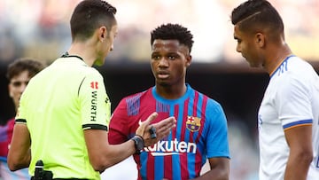 Jose Maria Sanchez Martinez, referee of the match, talks to Ansu Fati of FC Barcelona during the spanish league, La Liga Santander, football match played between FC Barcelona and Real Madrid at Camp Nou stadium on October 24, 2021, in Barcelona, Spain.
 A