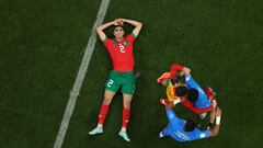 DOHA, QATAR - DECEMBER 10: (EDITORS NOTE: Image was rotated from its original perspective.) Achraf Hakimi of Morocco celebrates with Yassine Bounou of Morocco and other teammates after the 1-0 win during the FIFA World Cup Qatar 2022 quarter final match between Morocco and Portugal at Al Thumama Stadium on December 10, 2022 in Doha, Qatar. (Photo by Lars Baron/Getty Images)