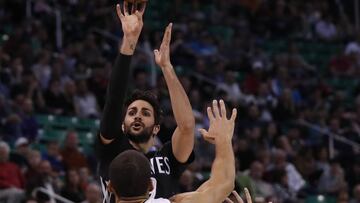 Apr 7, 2017; Salt Lake City, UT, USA; Minnesota Timberwolves guard Ricky Rubio (9) shoots a three-pointer against Utah Jazz center Rudy Gobert (27) and Utah Jazz guard Dante Exum (11) in the first quarter at Vivint Smart Home Arena. Mandatory Credit: Jeff Swinger-USA TODAY Sports