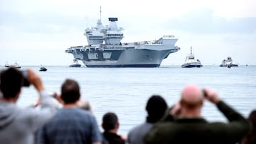 PORTSMOUTH, ENGLAND - AUGUST 16: Members of the public gather to witness the arrival of the HMS Queen Elizabeth supercarrier as it heads into port on August 16, 2017 in Portsmouth, England. The HMS Queen Elizabeth is the lead ship in the new Queen Elizabeth class of supercarriers. Weighing in at 65,000 tonnes she is the largest war ship deployed by the British Royal Navy. (Photo by Leon Neal/Getty Images)
