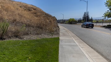 Recently watered grass is seen next to a dry-up area while extreme weather conditions including record-breaking heat waves are the latest sign of climate change in the western United States, where wildfires and severe drought have emerged as a growing threat, near San Jose, California, U.S., August 15, 2022. REUTERS/Carlos Barria