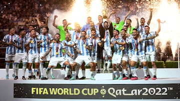 FILE PHOTO: Soccer Football - FIFA World Cup Qatar 2022 - Final - Argentina v France - Lusail Stadium, Lusail, Qatar - December 18, 2022 Argentina's Lionel Messi celebrates with the trophy and teammates after winning the World Cup REUTERS/Carl Recine/File Photo