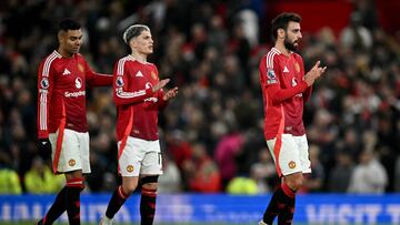 Chelsea's Argentinian midfielder #08 Enzo Fernandez (R) Manchester United's Argentinian midfielder #17 Alejandro Garnacho (C) and Manchester United's Brazilian midfielder #18 Casemiro applauds the fans following the English Premier League football match between Manchester United and Chelsea at Old Trafford in Manchester, north west England, on November 3, 2024. (Photo by Paul ELLIS / AFP) / RESTRICTED TO EDITORIAL USE. No use with unauthorized audio, video, data, fixture lists, club/league logos or 'live' services. Online in-match use limited to 120 images. An additional 40 images may be used in extra time. No video emulation. Social media in-match use limited to 120 images. An additional 40 images may be used in extra time. No use in betting publications, games or single club/league/player publications. /