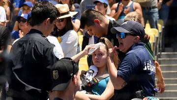 LOS ANGELES, CALIFORNIA - JUNE 23: An injured fan is escorted on a stretcher after she was hit by a foul ball off the bat of Cody Bellinger #35 of the Los Angeles Dodgers during the first inning against the Colorado Rockies at Dodger Stadium on June 23, 2019 in Los Angeles, California.   Harry How/Getty Images/AFP
 == FOR NEWSPAPERS, INTERNET, TELCOS &amp; TELEVISION USE ONLY ==