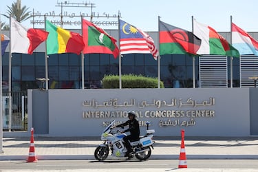 Un agente de policía en motocicleta se encuentra frente al Centro Internacional de Congresos, antes de una cumbre internacional sobre Gaza.