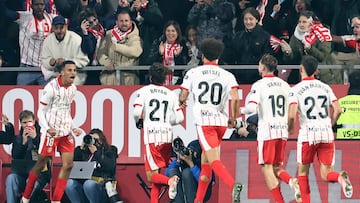 Girona's Moroccan midfielder #18 Azzedine Ounahi (L) celebrates scoring the opening goal during the Spanish league football match between Girona FC and Real Madrid CF at Montilivi Stadium in Girona on November 30, 2025. (Photo by Josep LAGO / AFP)
