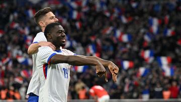 France's midfielder #19 Youssouf Fofana celebrates scoring his team's first goal with France's forward #09 Olivier Giroud during the friendly football match between France and Chile at the Stade Velodrome in Marseille, southern France, on March 26, 2024. (Photo by NICOLAS TUCAT / AFP)