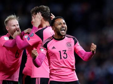 Scotland's Ikechi Anya celebrates after his side's 89th minute goal against Slovakia that keeps them in with a chance of qualifying for Russia 2018. Scotland's away kit for the qualifying campaign has been this bright pink number that's been a huge hit wi