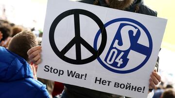 KARLSRUHE, GERMANY - FEBRUARY 26: A FC Schalke 04 fan holds a sign to indicate peace and sympathy with Ukraine during the Second Bundesliga match between Karlsruher SC and FC Schalke 04 at BBBank Wildpark on February 26, 2022 in Karlsruhe, Germany. Schalk