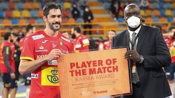 Spain&#039;s centre back Raul Entrerrios (L) is awarded player of the game during the 2021 World Men&#039;s Handball Championship match between Group I teams Spain and Germany at the New Capital Sports Hall in the Egyptian capital Cairo on January 21, 202