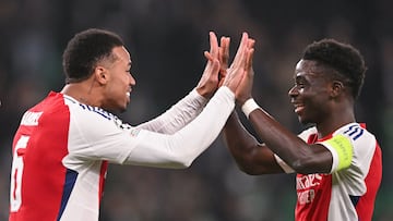 Arsenal's Brazilian defender #06 Gabriel Magalhaes (L) celebrates with teammate Arsenal's English midfielder #07 Bukayo Saka after their UEFA Champions League, league phase day 5 football match between Sporting CP and Arsenal FC, at the Jose Alvalade stadium in Lisbon, on November 26, 2024. (Photo by PATRICIA DE MELO MOREIRA / AFP)