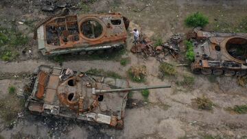 IRPIN, UKRAINE - MAY 25: People photograph and inspoect destroyed Russian main battle tanks and armoured vehicles laying beside a road on May 25, 2022 in Irpin, Ukraine. As Russia concentrates its attack on the east and south of the country, residents of 