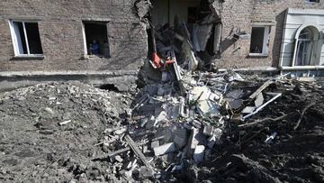 A picture shows a crater from a missile hit in front of a partially destroyed residential building in the Ukrainian town of Bakhmut, on July 1, 2022, amid Russia's military invasion launched on Ukraine. (Photo by Genya SAVILOV / AFP) (Photo by GENYA SAVILOV/AFP via Getty Images)