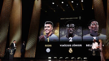 Manchester City's Spanish midfielder Rodri (L) receives the Ballon d'Or award from former President of Liberia and former Liberian football player George Weah (2L