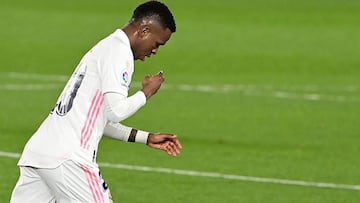 Real Madrid's Brazilian forward Vinicius Junior crosses himself as he celebrates after scoring a goal during the Spanish league football match between Real Madrid CF and Real Sociedad at the Alfredo di Stefano stadium in Valdebebas, on the outskirts